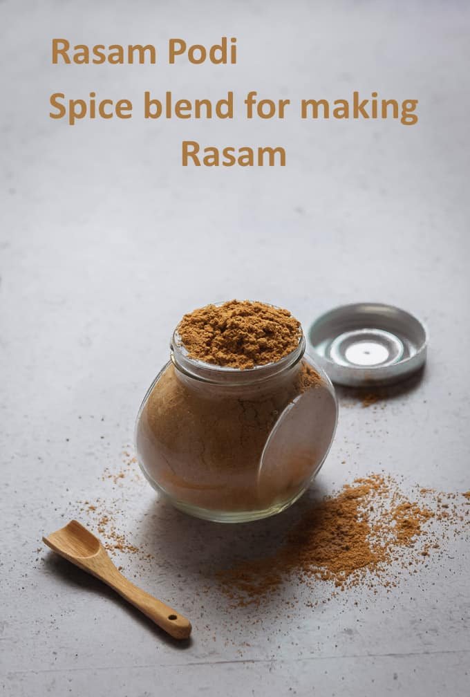 Rasam powder prepared at home displayed in a glass jar with backlighting.