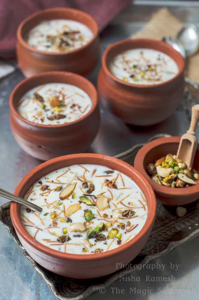 semiya payasam vermiceli kheer in a clay bowl and exotic nuts on the side.